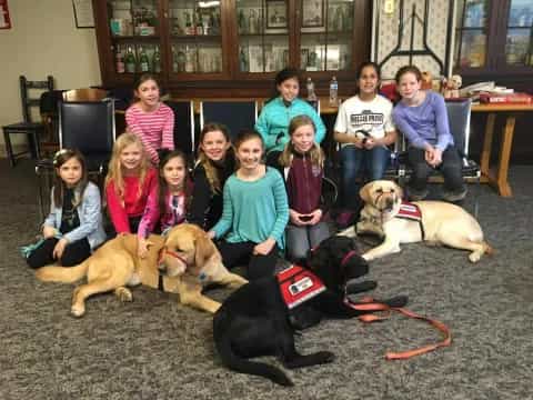 a group of people with dogs