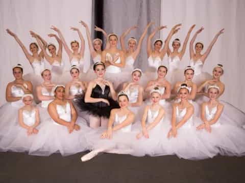 a group of women in white dresses