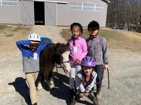 a group of people with a horse