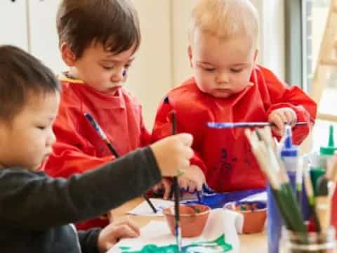 a group of children painting