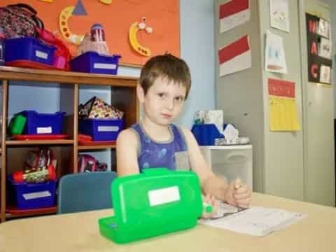 a boy sitting at a table