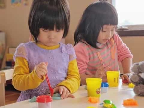 a couple of young girls painting