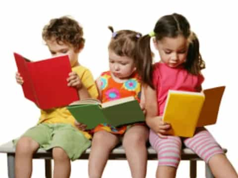 a group of children reading books