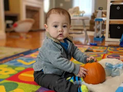 a baby sitting on the floor