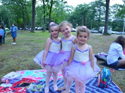 a group of girls in dresses