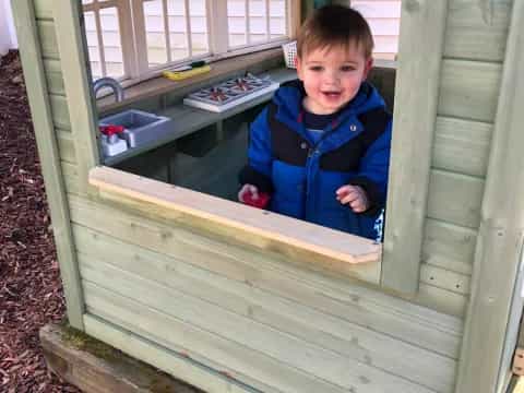 a boy in a wooden shed