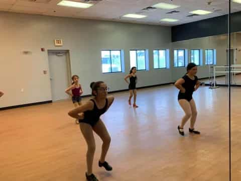 a group of women exercising in a gym