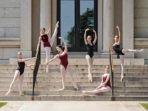a group of women posing on stairs