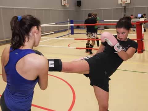 a couple of people boxing