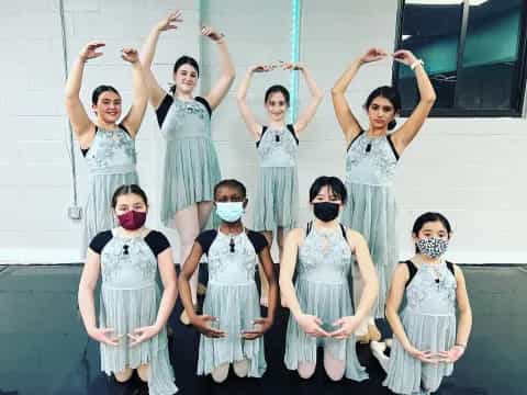 a group of women in white dresses