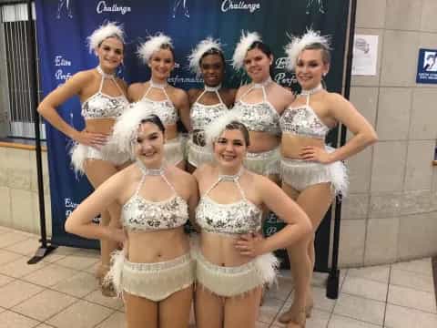 a group of women in white dresses