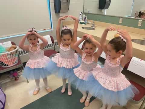 a group of girls in dresses