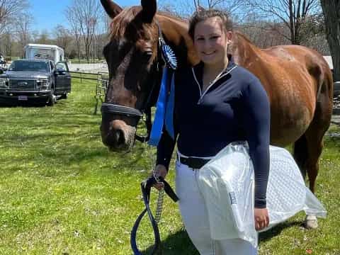 a woman holding a horse