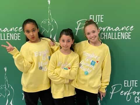a group of girls in yellow shirts