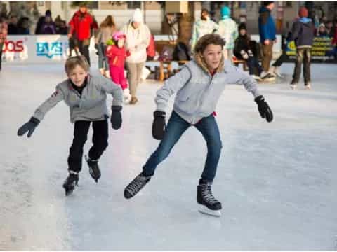 a couple of people ice skating