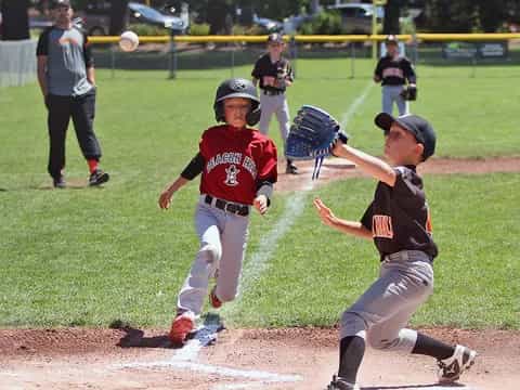 kids playing baseball on a field