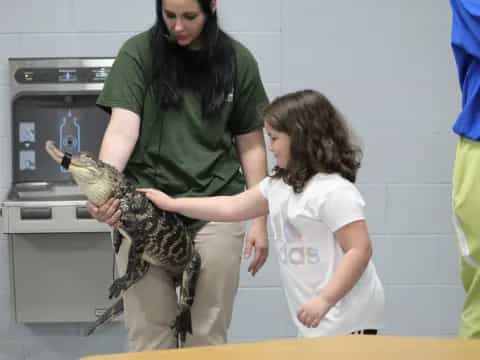 a person holding a reptile