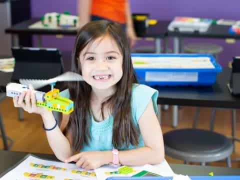 a girl holding a toy