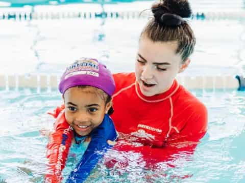 a person and a child in a pool