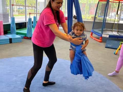 a person and a child in a gym