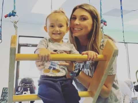 a person and a boy in a gym