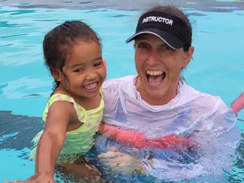 a person and a child in a pool