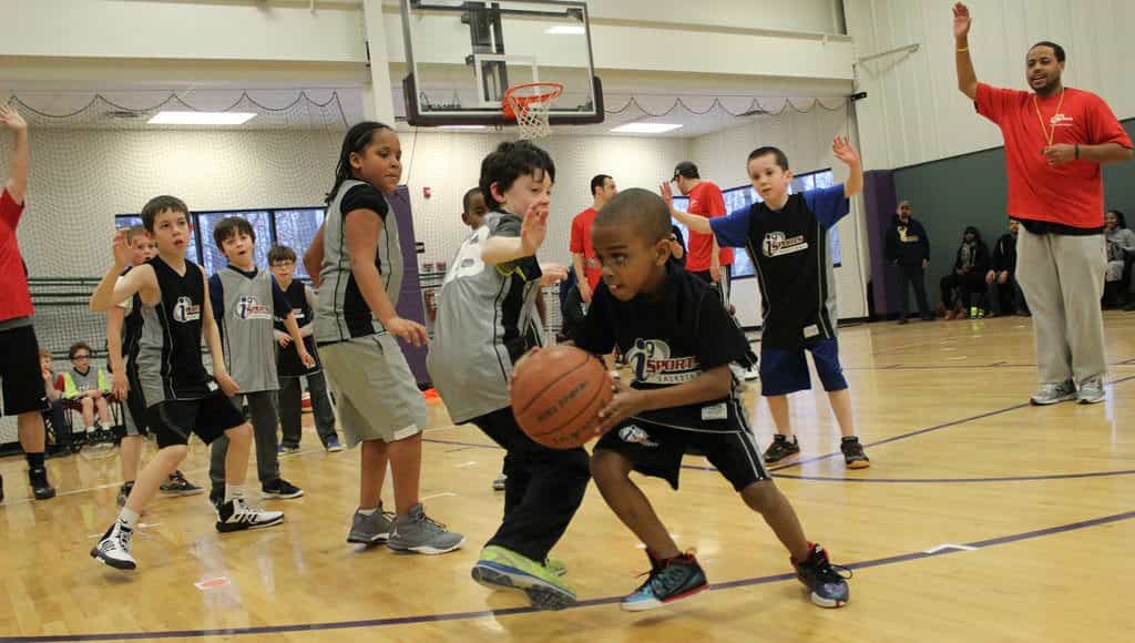 a group of kids playing basketball