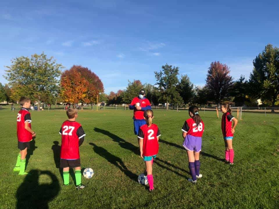 a group of kids playing football