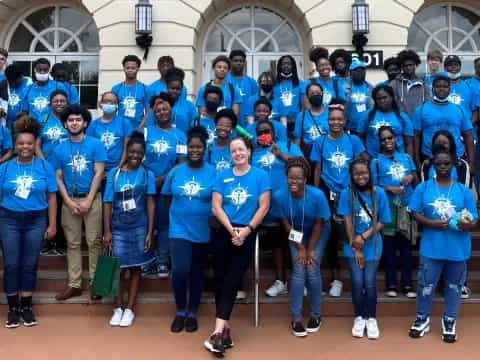 a group of people wearing matching blue shirts