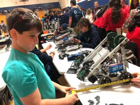 a group of people working on a toy car