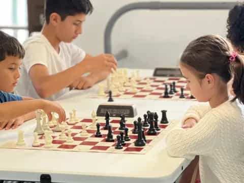 a group of children playing chess