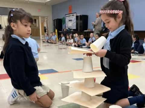 a couple of girls in a classroom