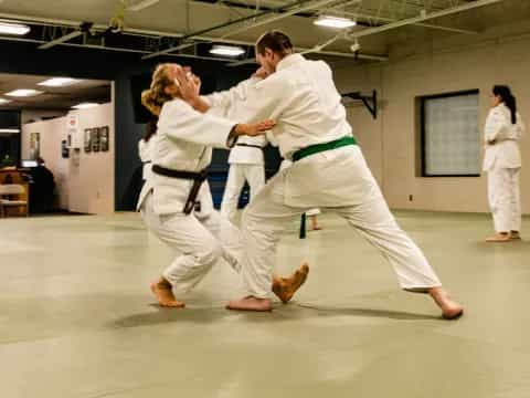 a man and woman in karate uniforms