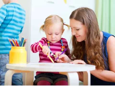 a person and a child painting