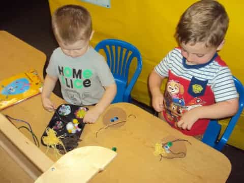 two boys playing with toys