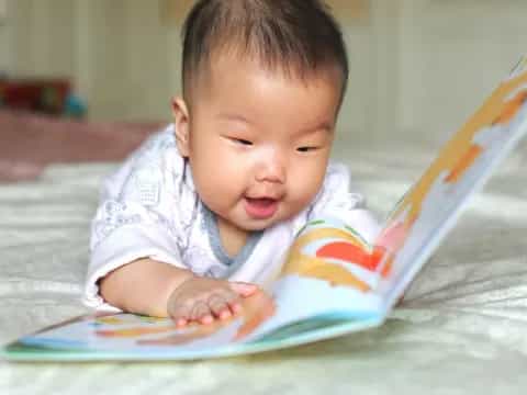 a baby looking at a book