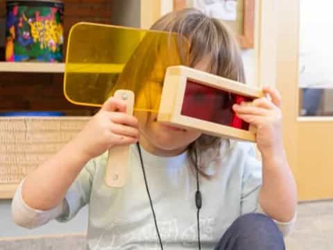 a girl holding a device to her ear