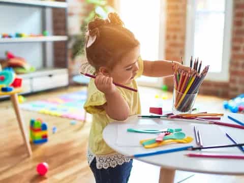 a child painting on a table