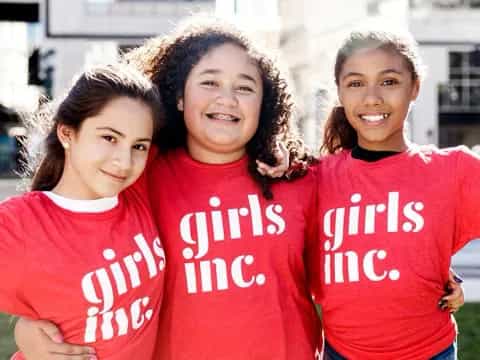 a group of girls in red shirts