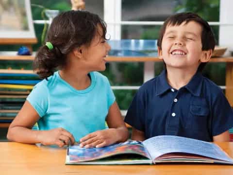 a person and a boy reading a book