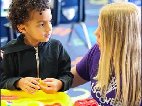 a boy and girl playing with toys