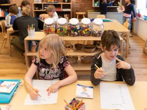 a few children sitting at a table