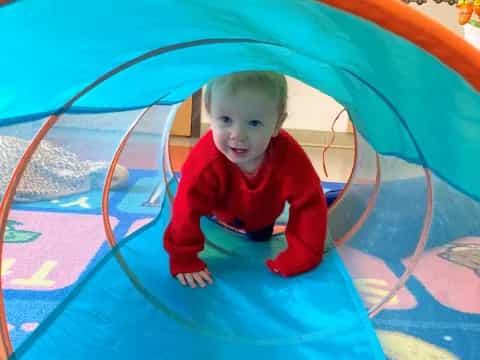 a baby in a ball pit