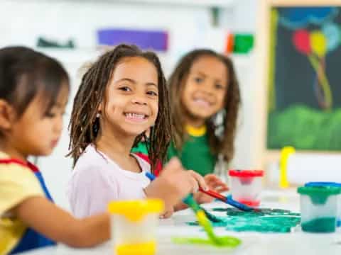 a group of children painting