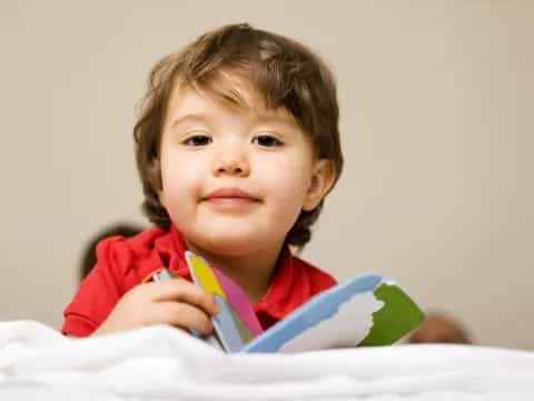 a child holding a book