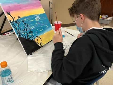 a person painting on a table