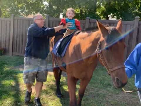 a man and a child riding a horse