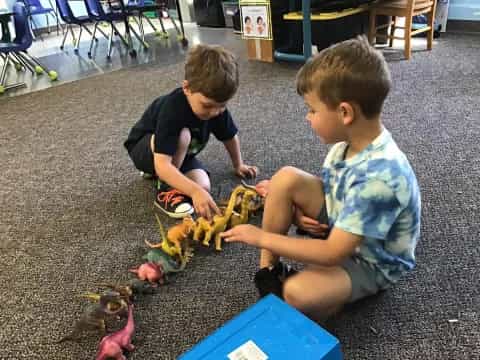 two boys playing with toys