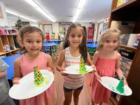 a group of girls holding cake