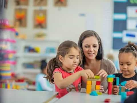 a person and children playing with toys